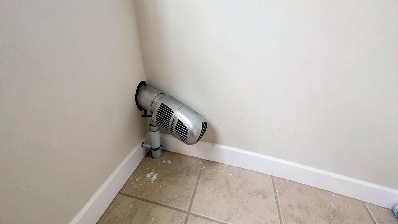 Dryer Vent Lint Removal, After: The same dryer vent cleaned, reconnected, and the floor cleared of lint